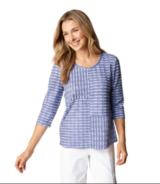 Woman wearing a pink and white striped top with a beige background