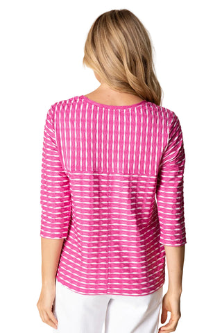 Woman wearing a pink and white striped shirt against a beige background