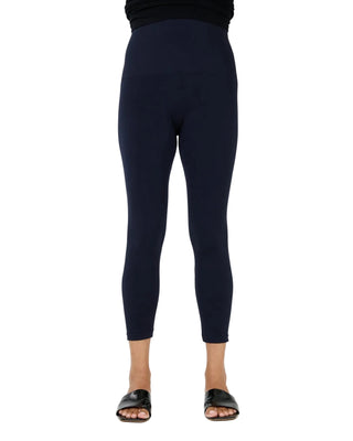 Navy leggings worn by a person on a white background