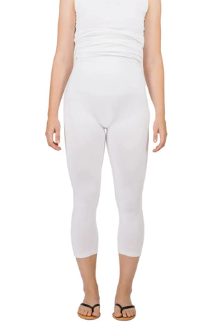Person wearing white capri pants on a plain background