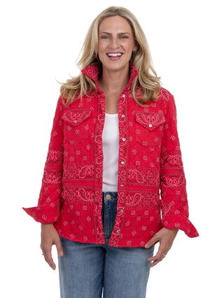Woman wearing a red bandana print jacket on a white background