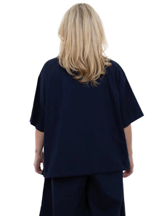 Person wearing a navy blue outfit on a white background