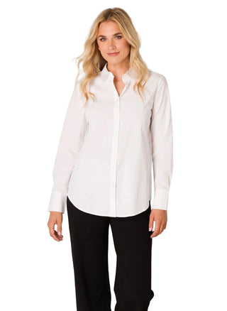 A woman modeling a white long-sleeve button-up shirt with black pants, standing against a light gray studio background.