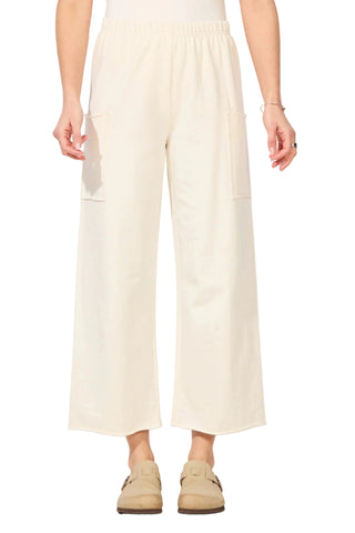 Person wearing light-colored pants and beige shoes on a white background
