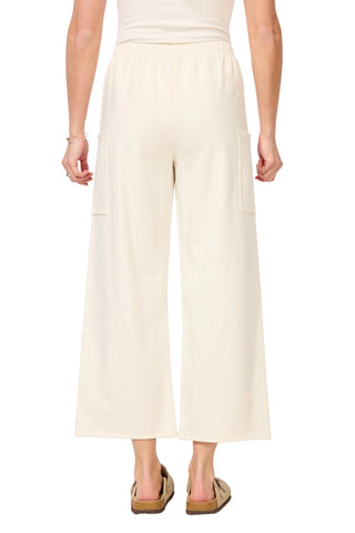 Person wearing light-colored pants on a plain background