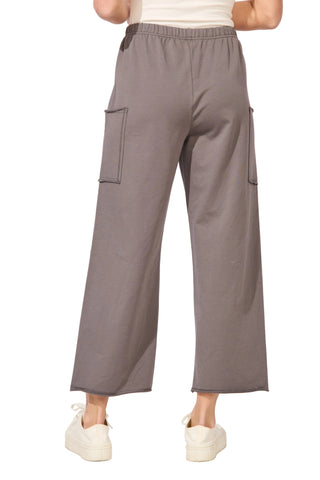 Gray cargo pants worn by a person on a white background