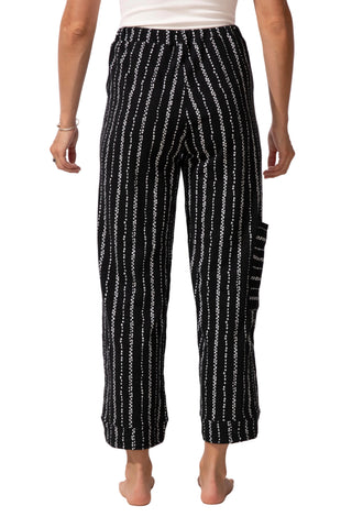 Black and white striped pants worn by a person on a white background