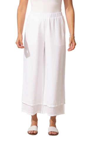 Person wearing white wide-leg pants on a plain background