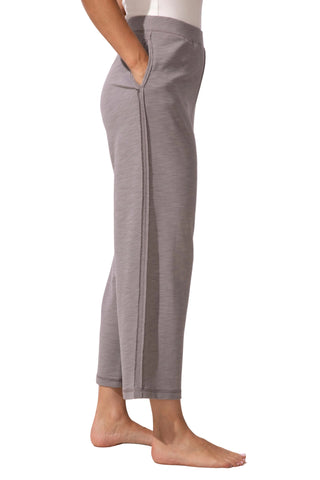 Person wearing gray pants on a plain background