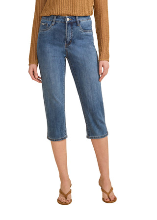 Person wearing blue jeans and a brown top on a beige background