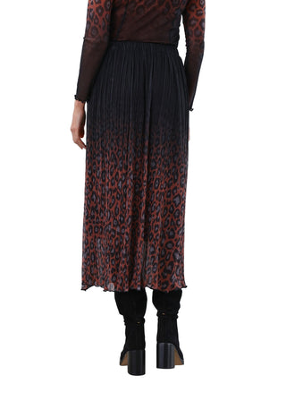 Person wearing a dress with a gradient pattern from black to red on a white background