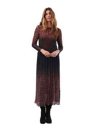 Woman wearing a patterned dress with a plain white background