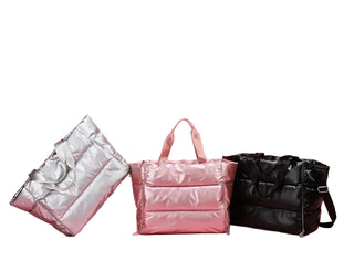 Three bags in metallic silver, pink, and black on a pink background