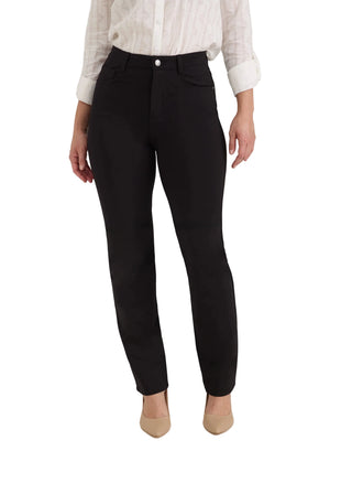 A model wearing black slim-fit trousers, a white long-sleeve button-up shirt, and beige pointed-toe heels, shown from the waist down against a light gray studio background.