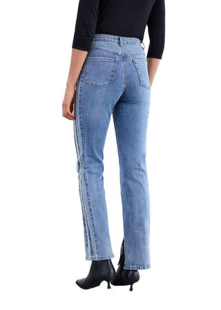 Person wearing light blue jeans with a white background
