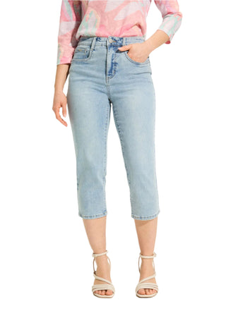 Person wearing light blue jeans and a tie-dye shirt on a white background