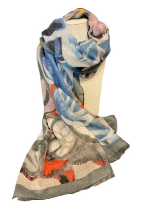 A lightweight rectangular scarf with fringed edges draped over a white mannequin torso. The scarf features an abstract painterly pattern in shades of blue, gray, white, black, and bright orange.