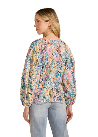 Woman wearing a floral blouse with a beige background