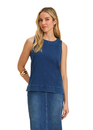 Woman wearing a blue sleeveless top and skirt on a beige background