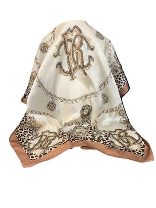 Decorative scarf with intricate patterns and embroidery on a chair.