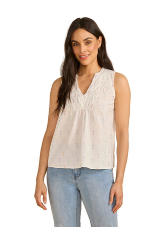 Woman wearing a white sleeveless top with a beige background