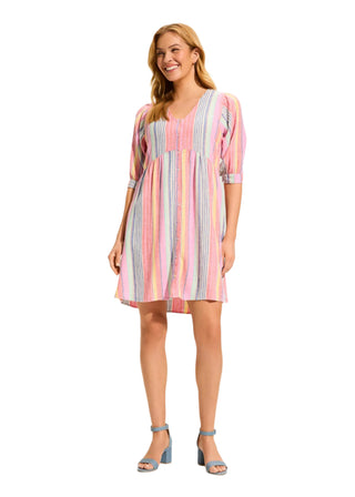 Woman wearing a colorful striped dress on a white background