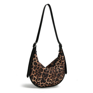 Leopard print handbag with a black strap on a white background