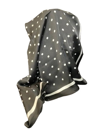 Black polka dot scarf draped over a chair