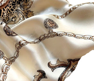 Beige fabric with intricate brown patterns, including chains and decorative elements.