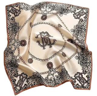 Decorative scarf with jewelry and monogram design on a beige background