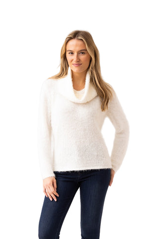Woman wearing a white sweater with a cowl neck on a white background