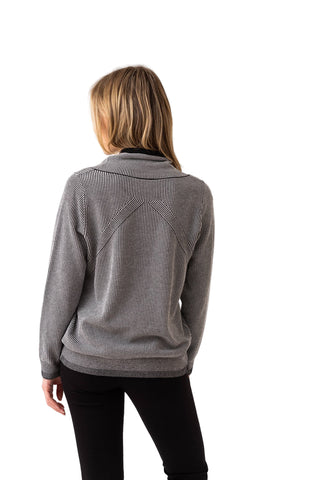 Person wearing a gray sweater on a white background