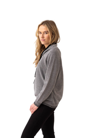 Woman wearing a gray sweater on a white background