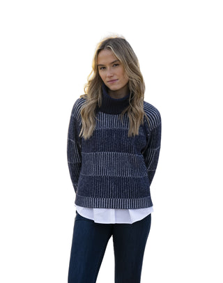 Woman wearing a striped sweater on a beach