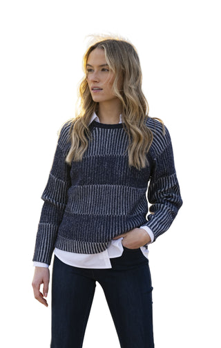 Woman wearing a patterned sweater on a beach