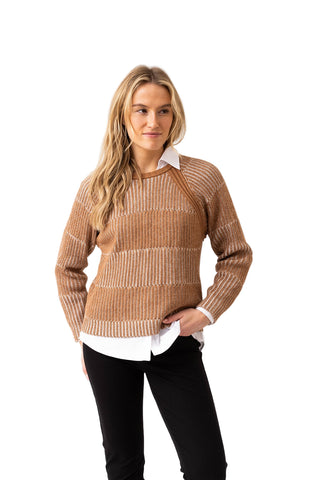 Woman wearing a brown ribbed sweater over a white shirt on a white background