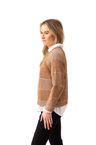 Woman wearing a beige knitted sweater over a white shirt on a white background