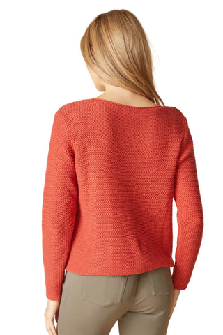 Person wearing a red sweater on a beige background