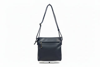 navy leather handbag on a white stand against a light gray background