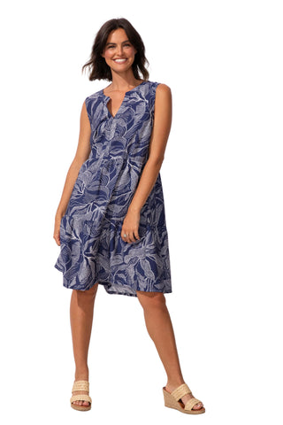 Woman wearing a blue patterned dress against a white background