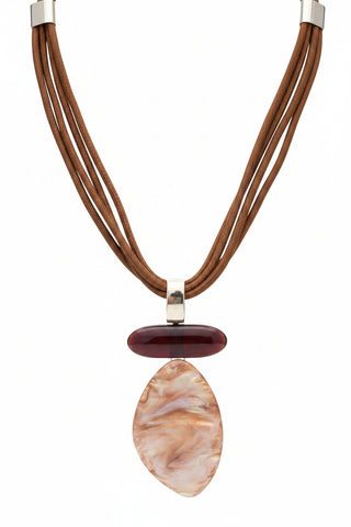 A multi-strand brown cord necklace displayed on a black mannequin bust, featuring a polished dark reddish-brown oval stone, a larger teardrop-shaped iridescent shell-like piece in brown and gold tones, and a small silver-toned metal connector.