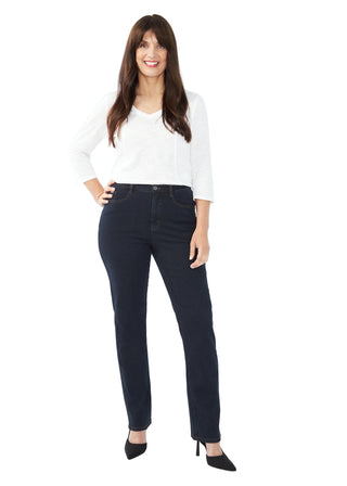Woman wearing dark jeans and a white top on a white background