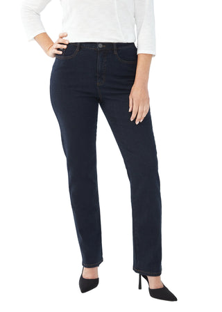 Person wearing dark blue jeans and a white top on a white background