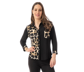 A woman modeling a long-sleeve button-up blouse with a black body and leopard print panels on the chest, sleeves, and pocket, paired with black pants against a white background.
