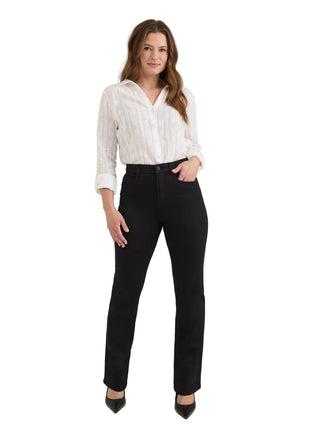 A woman modeling a white textured long-sleeve blouse and black straight-leg jeans against a light gray studio background.