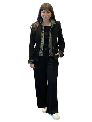 Person standing in front of a branded backdrop with 'Anne's on the Avenue' logo.
