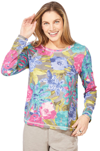 Woman wearing a colorful floral long-sleeve shirt on a white background