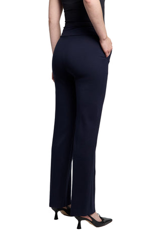 Person wearing navy blue pants on a plain background