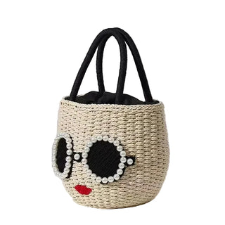 Woven basket with sunglasses and lips design on a light background