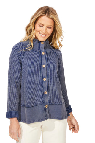 Woman wearing a blue checkered jacket with wooden buttons on a white background